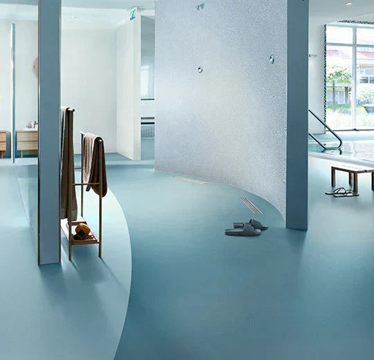 Modern interior showcasing rubber flooring installation in a spacious area with minimalist design.