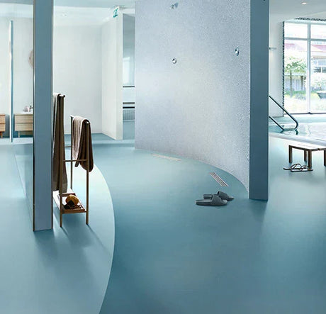 Modern interior showcasing rubber flooring installation in a spacious area with minimalist design.