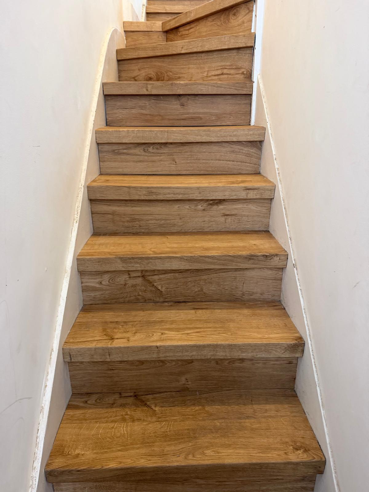 Oak-effect LVT staircase installation in Ealing, London, with stair nosings fitted by EXEN Flooring.