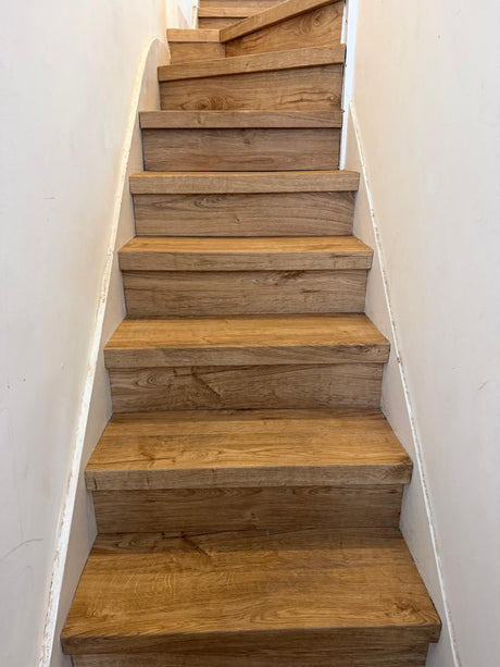 Oak-effect LVT staircase installation in Ealing, London, with stair nosings fitted by EXEN Flooring.