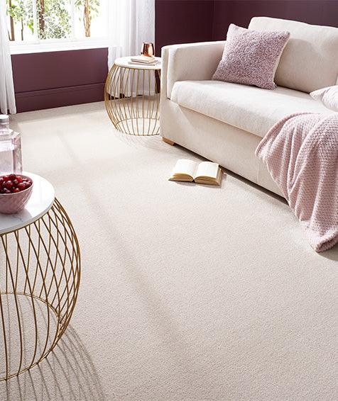 Soft beige carpet flooring in a cozy living room with modern furniture and natural light